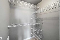 Closet with multiple white wire shelving units - 