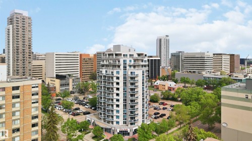 Modern high-rise building featuring multiple levels of balconies, a curved facade, and ground-level commercial spaces - 901 10504 99 Avenue, Edmonton, AB 