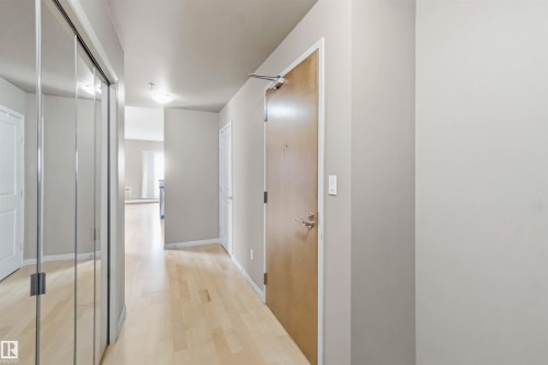 Entryway featuring wood-finish flooring, light neutral wall tones, and recessed ceiling lighting - 901 10504 99 Avenue, Edmonton, AB 