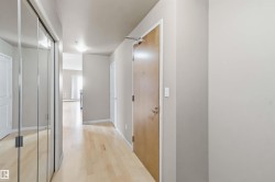 Entryway featuring wood-finish flooring, light neutral wall tones, and recessed ceiling lighting - 