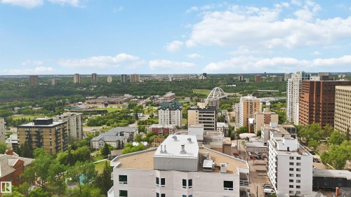 Expansive cityscape featuring a mix of mid-rise and high-rise buildings, extensive green spaces, and a prominent arched bridge - 901 10504 99 Avenue, Edmonton, AB 