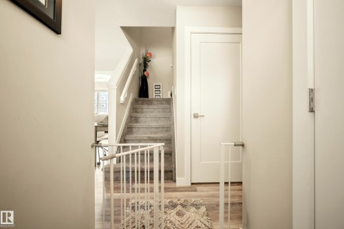 Carpeted staircase with white balusters and handrails - 4013 Blackbird Link, Edmonton, AB 