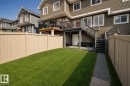 Private fenced yard with a manicured lawn and paver walkway - 4013 Blackbird Link, Edmonton, AB 