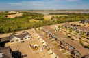 Aerial perspective of a multi-unit residential development with light gray siding and brown shingle roofing - 4013 Blackbird Link, Edmonton, AB 