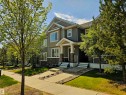 Contemporary multi-level residence featuring mixed material siding, a stone facade on the lower level, and a covered front porch with stone-clad columns - 4013 Blackbird Link, Edmonton, AB 