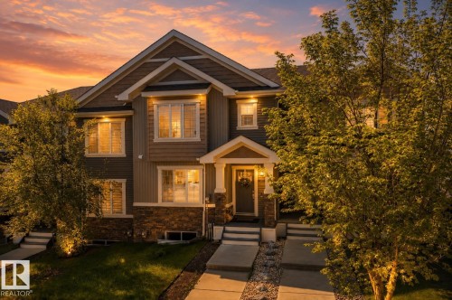 Multi-level facade featuring stone and siding finishes - 4013 Blackbird Link, Edmonton, AB 