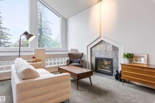 Vaulted ceilings with expansive windows, stone fireplace, and glass block accents - 10 Everest Crescent, St. Albert, AB 