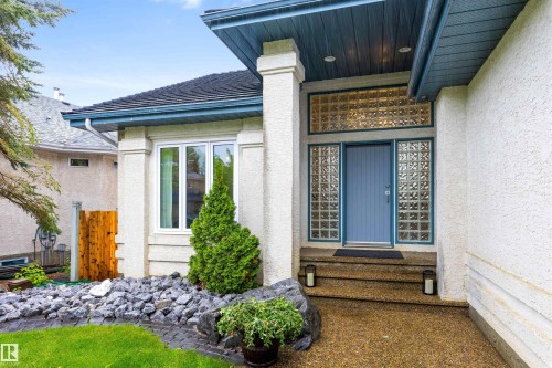 Entryway featuring a blue door flanked by glass block sidelights and a transom - 10 Everest Crescent, St. Albert, AB 