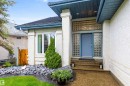 Entryway featuring a blue door flanked by glass block sidelights and a transom - 10 Everest Crescent, St. Albert, AB 