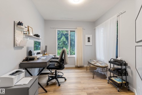 Spacious interior room featuring light-toned walls and wood-finish flooring - 10 Everest Crescent, St. Albert, AB 