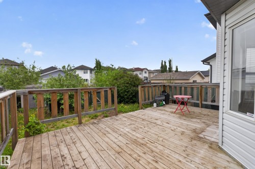 Exterior wood deck with a perimeter railing and a white vinyl-sided wall - 8 Vega Avenue, Spruce Grove, AB - Outdoor With Deck Patio Veranda With Exterior