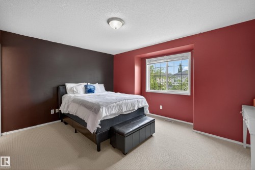 Spacious room featuring neutral carpeting, a large window with white blinds, and a ceiling-mounted light fixture - 8 Vega Avenue, Spruce Grove, AB - Indoor Photo Showing Bedroom