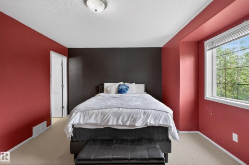Carpeted room featuring a window with blinds, a white door frame, and a flush mount ceiling light - 8 Vega Avenue, Spruce Grove, AB - Indoor Photo Showing Bedroom