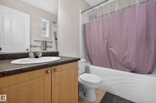 Bathroom vanity featuring an integrated oval sink and dark speckled countertop - 8 Vega Avenue, Spruce Grove, AB - Indoor Photo Showing Bathroom
