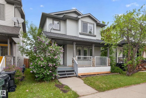 Two-story residence featuring light gray siding with dark gray trim accents and a covered front porch - 8 Vega Avenue, Spruce Grove, AB - Outdoor With Deck Patio Veranda