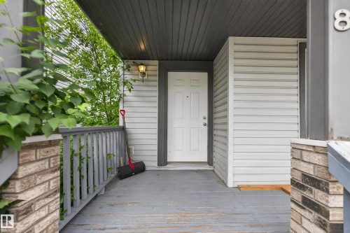 Covered front porch featuring a white entry door, light gray siding, and a coordinated gray railing - 8 Vega Avenue, Spruce Grove, AB - Outdoor With Exterior