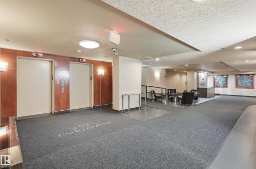 Building lobby featuring two elevators with wood-paneled surrounds - 1407 9939 109 Street, Edmonton, AB 