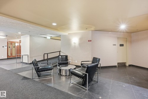 Building common area featuring a tiled floor, textured wall finishes, and recessed lighting - 1407 9939 109 Street, Edmonton, AB 