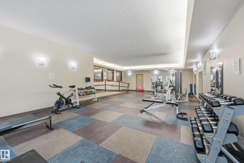 Well-appointed fitness facility featuring modular carpet tiles, recessed lighting, and wall-mounted sconces - 1407 9939 109 Street, Edmonton, AB 