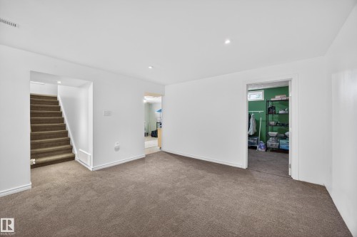 Spacious room with plush carpet flooring, white painted walls, and recessed lighting - 5216 104A Street, Edmonton, AB - Indoor Photo Showing Other Room