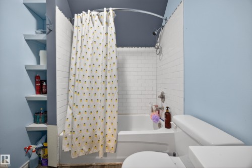White subway tile surround for the tub and shower combination - 5216 104A Street, Edmonton, AB - Indoor Photo Showing Bathroom
