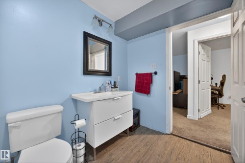 Bathroom with wood-finish flooring and light blue walls - 5216 104A Street, Edmonton, AB - Indoor Photo Showing Bathroom