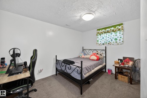 Carpeted room featuring white walls, a single window, and a flush-mount ceiling light fixture - 5216 104A Street, Edmonton, AB - Indoor Photo Showing Bedroom
