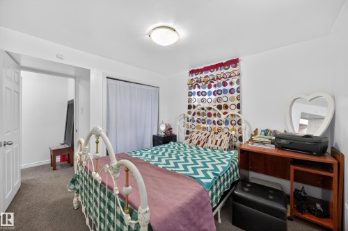 Carpeted bedroom featuring white walls and a ceiling-mounted light fixture - 5216 104A Street, Edmonton, AB - Indoor Photo Showing Bedroom