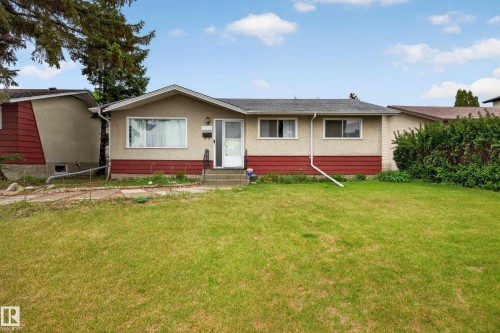 Exterior featuring a light stucco finish with a red accent band and a dark shingle roof - 5216 104A Street, Edmonton, AB - Outdoor