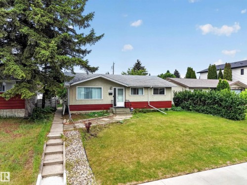 Ranch-style exterior with a light stucco finish and red siding accent - 5216 104A Street, Edmonton, AB - Outdoor