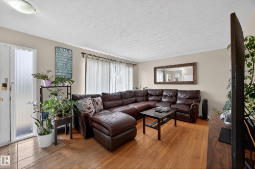 Living space featuring wood-finish flooring, neutral wall tones, and recessed lighting - 5216 104A Street, Edmonton, AB - Indoor Photo Showing Living Room
