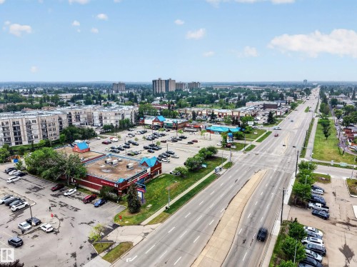 Urban landscape featuring multi-lane roadways, commercial buildings with parking, and multi-story residential structures - 5216 104A Street, Edmonton, AB - Outdoor With View