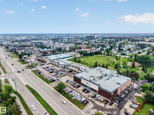 Expansive commercial property featuring multiple retail storefronts with ample surface parking - 5216 104A Street, Edmonton, AB - Outdoor With View