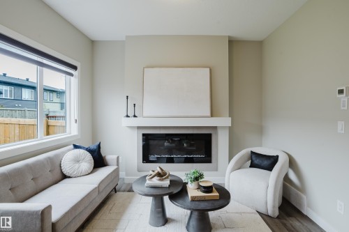 Contemporary living space featuring a built-in electric fireplace with a substantial mantelpiece - 9142 Pear Drive, Edmonton, AB - Indoor Photo Showing Living Room With Fireplace