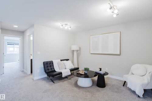 Carpeted living area featuring light neutral wall paint, white trim, and recessed lighting - 9142 Pear Drive, Edmonton, AB - Indoor Photo Showing Other Room