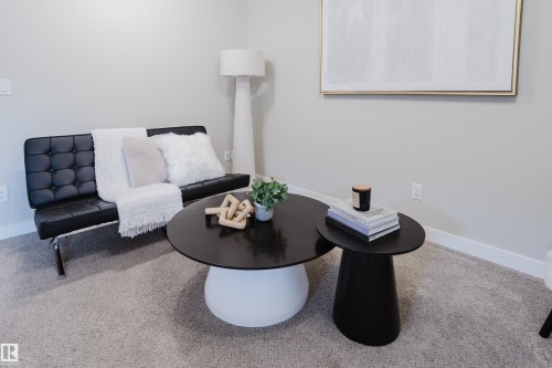 Light gray wall paint with white baseboards provides a neutral backdrop for the carpeted room - 9142 Pear Drive, Edmonton, AB - Indoor