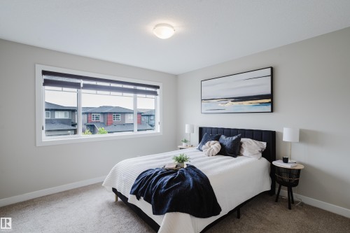 Spacious room featuring a large window with privacy blinds, light gray wall paint, and neutral-toned carpeting - 9142 Pear Drive, Edmonton, AB - Indoor Photo Showing Bedroom