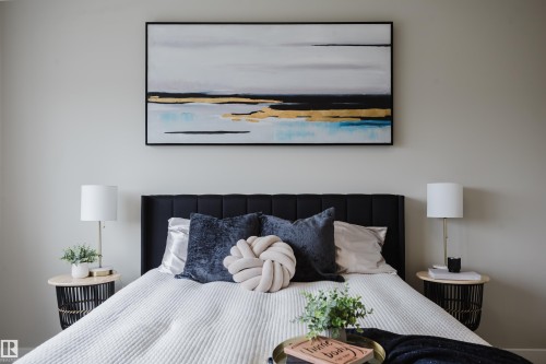 Recessed black upholstered headboard with an abstract art piece above - 9142 Pear Drive, Edmonton, AB - Indoor Photo Showing Bedroom