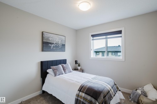 Room featuring light gray painted walls, a single window with a roller blind, and a semi-flush ceiling light fixture - 9142 Pear Drive, Edmonton, AB - Indoor Photo Showing Bedroom