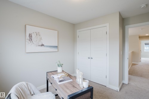 Neutral-toned room featuring light beige walls and complementing carpet flooring - 9142 Pear Drive, Edmonton, AB - Indoor