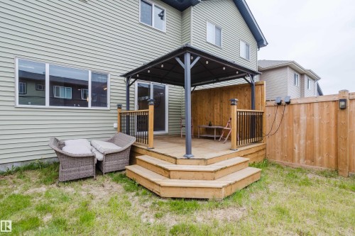 Rear exterior featuring a wooden deck with a gazebo, multi-level stairs, and a sliding glass door - 9142 Pear Drive, Edmonton, AB - Outdoor With Deck Patio Veranda With Exterior