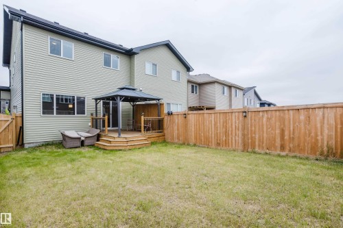 Spacious backyard featuring a wooden deck with a gazebo, full wooden fencing, and a grassy lawn - 9142 Pear Drive, Edmonton, AB - Outdoor With Deck Patio Veranda With Exterior