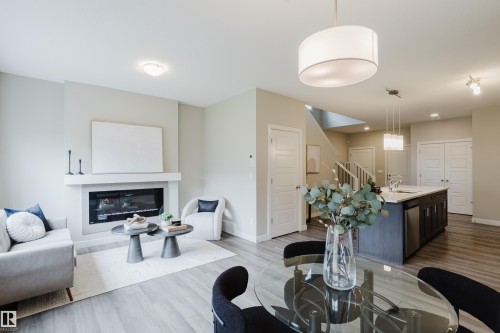 Open concept living area featuring wood-finish flooring - 9142 Pear Drive, Edmonton, AB - Indoor Photo Showing Living Room With Fireplace