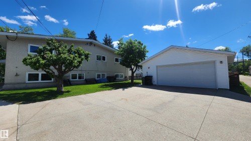 Detached two-car garage with white siding and a concrete driveway - 8824 90 Street, Edmonton, AB 