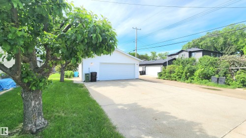 Detached two-car garage with white siding and a concrete driveway - 8824 90 Street, Edmonton, AB 