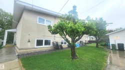 Stucco exterior with white trim windows and a covered side entrance - 