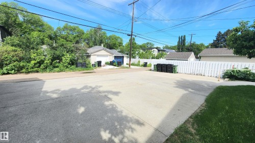 Paved driveway with a white picket fence bordering the property - 8824 90 Street, Edmonton, AB 