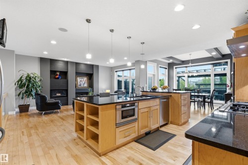 Open concept living area featuring natural wood-finish flooring - 5709 Mcluhan Bay, Edmonton, AB 