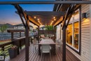 Expansive wood-finish deck featuring a dark wood pergola with string lighting - 5709 Mcluhan Bay, Edmonton, AB 