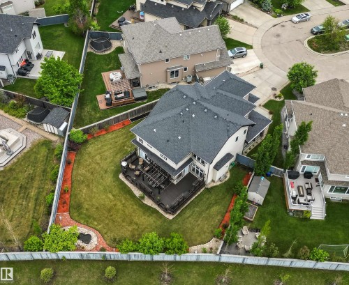 Expansive backyard featuring a large composite deck, pergola, and manicured lawn - 5709 Mcluhan Bay, Edmonton, AB 